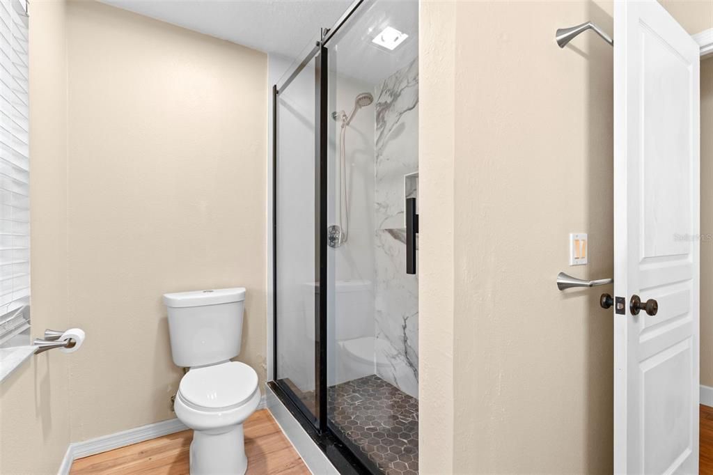 Bathroom, Glass Shower, Interior, Marble Walls, Wood Texture Flooring