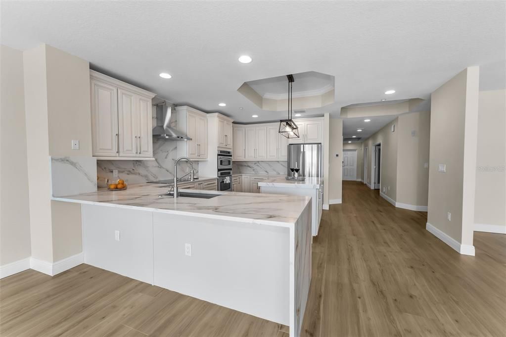 Interior, Kitchen, Marble Walls, Pendant Lights, Recessed Lighting, Stainless Steel Appliances, Wood Texture Flooring