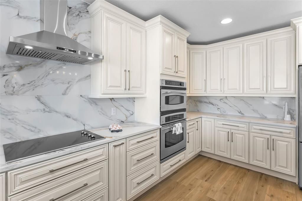 Interior, Kitchen, Marble Walls, Recessed Lighting, Stainless Steel Appliances, Wood Texture Flooring