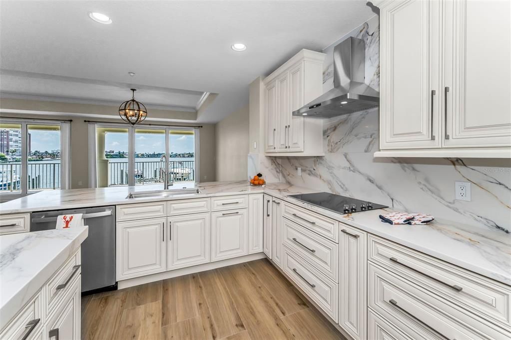 Interior, Kitchen, Marble Walls, Pendant Lights, Recessed Lighting, Stainless Steel Appliances, Water, Wood Texture Flooring