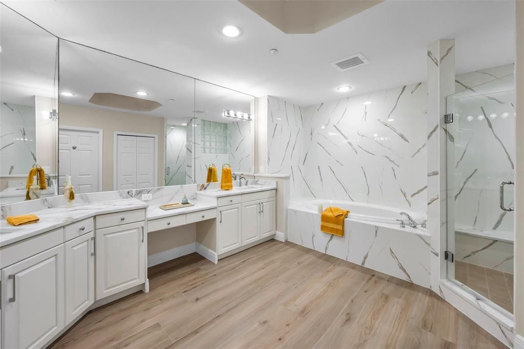 Bathroom, Dual Sink Vanities, Glass Shower, Interior, Marble Walls, Recessed Lighting, Wood Texture Flooring