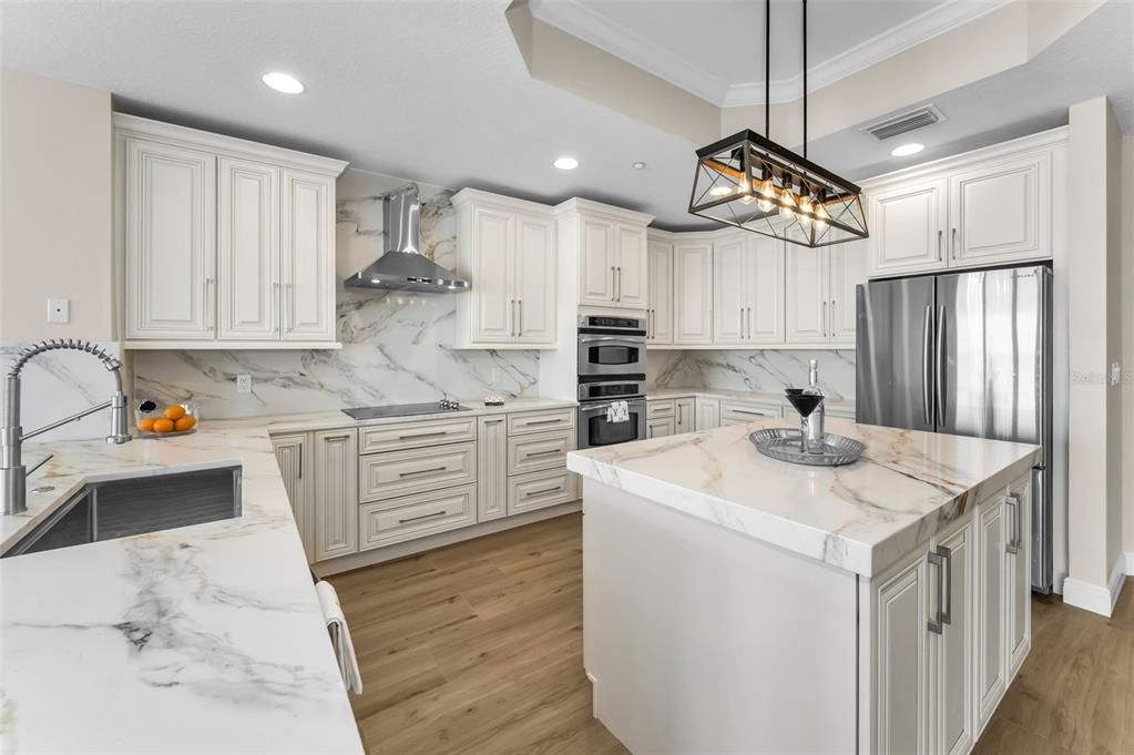 Interior, Kitchen, Marble Walls, Pendant Lights, Recessed Lighting, Stainless Steel Appliances, Wood Texture Flooring