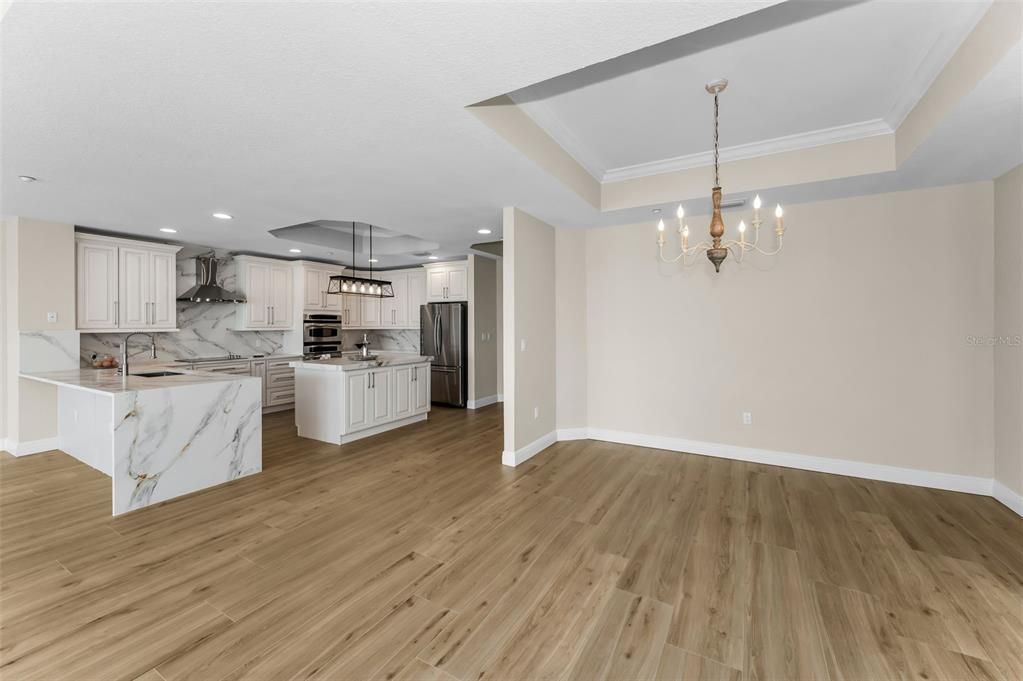 Chandelier, Interior, Kitchen, Marble Walls, Pendant Lights, Recessed Lighting, Stainless Steel Appliances, Wood Texture Flooring