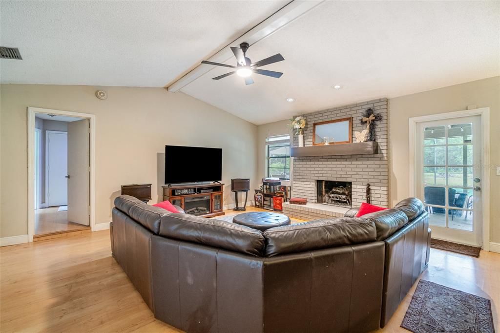 Fireplace, Interior, Living room, Recessed Lighting, Stone Walls, Wood Texture Flooring