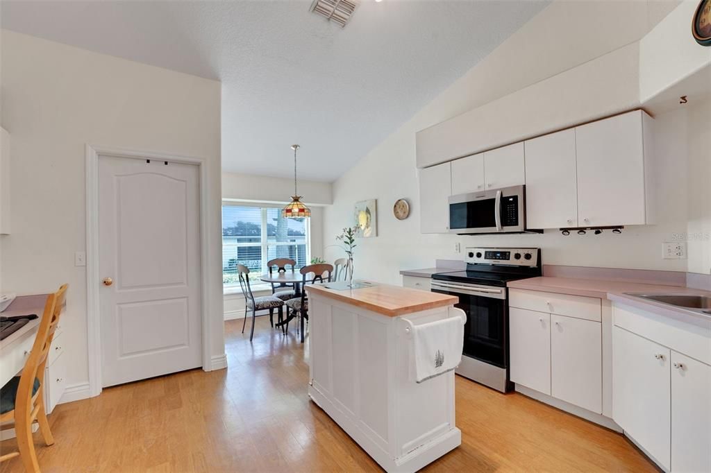 Dining room, Interior, Kitchen, Pendant Lights, Stainless Steel Appliances, Water, Wood Texture Flooring