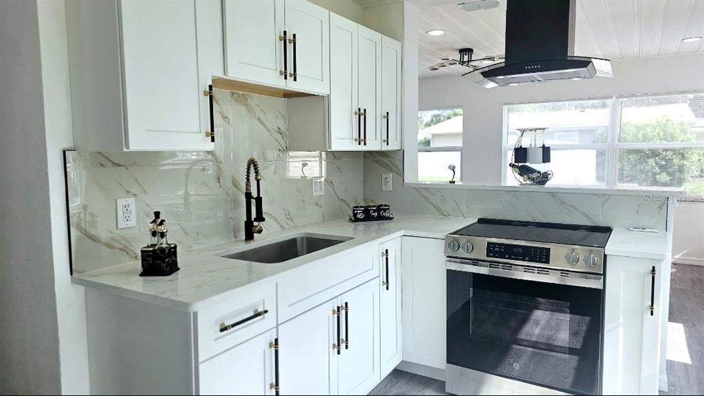 Interior, Kitchen, Marble Walls, Recessed Lighting, Stainless Steel Appliances, Wood Texture Flooring
