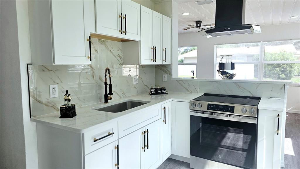 Interior, Kitchen, Marble Walls, Recessed Lighting, Stainless Steel Appliances, Wood Texture Flooring