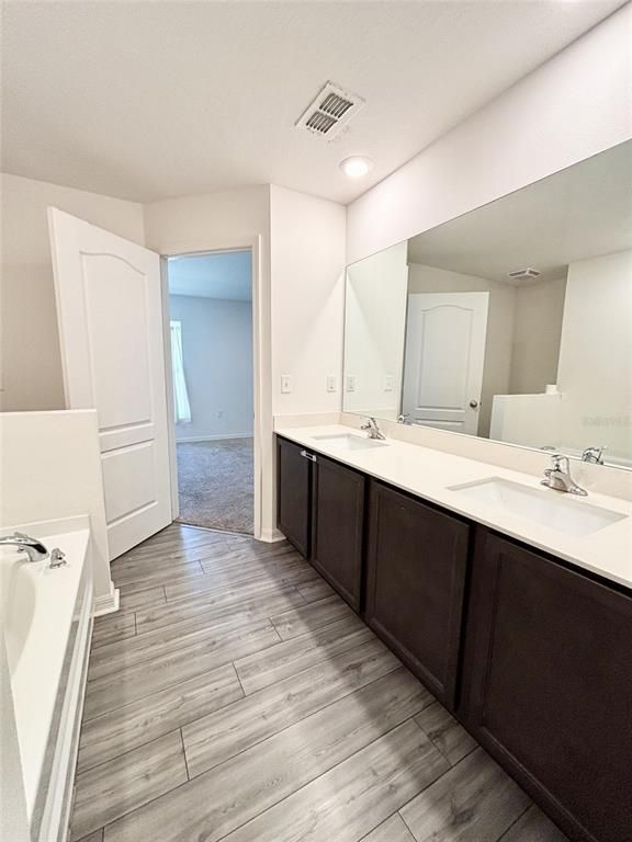 Bathroom, Dual Sink Vanities, Interior, Recessed Lighting, Wood Texture Flooring