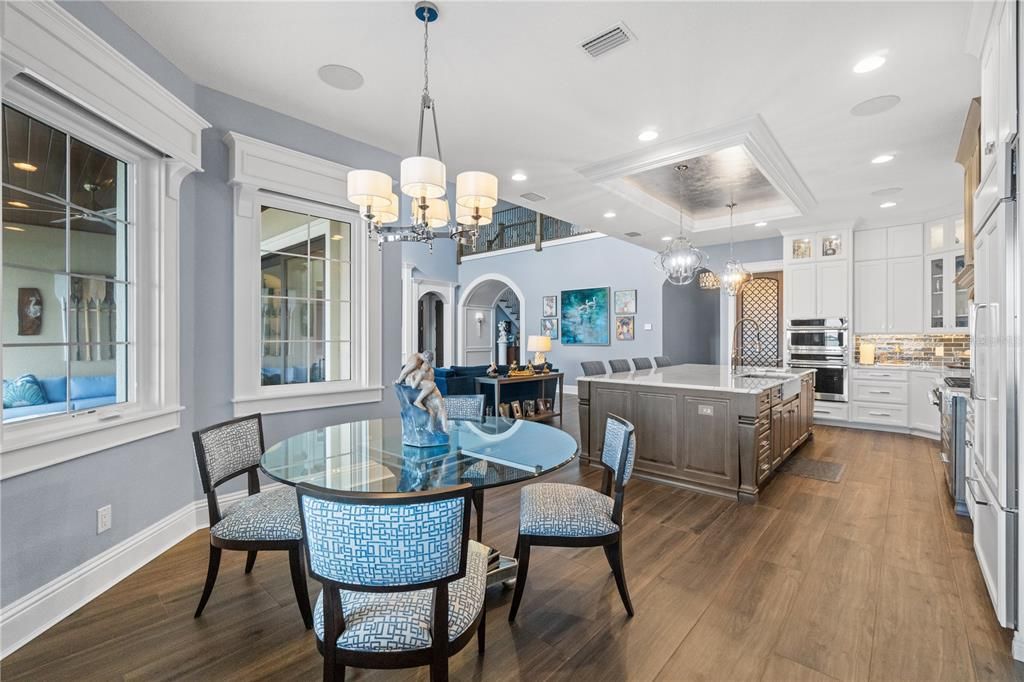 Chandelier, Dining room, Interior, Kitchen, Living room, Pendant Lights, Recessed Lighting, Stainless Steel Appliances, Wood Texture Flooring