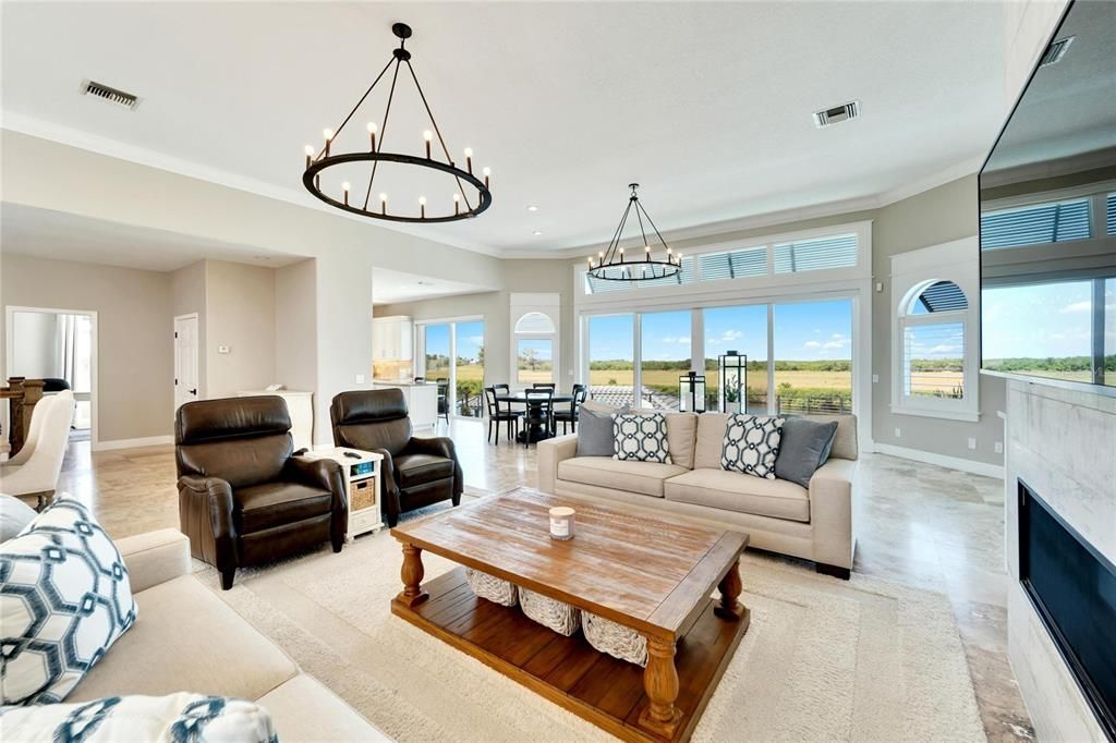 Chandelier, Dining room, Fireplace, Interior, Living room, Pendant Lights, Recessed Lighting, Wood Texture Flooring