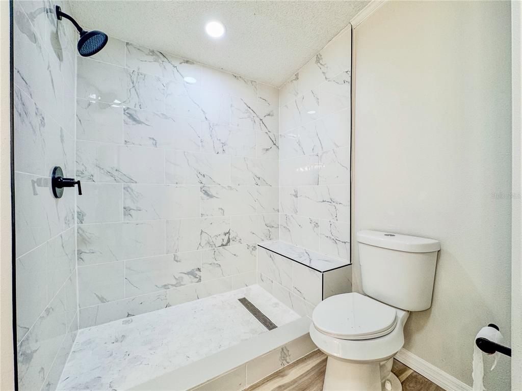 Bathroom, Glass Shower, Interior, Marble Walls, Recessed Lighting, Wood Texture Flooring
