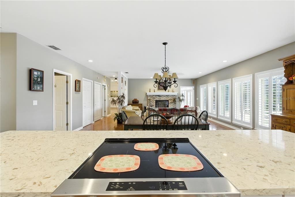 Chandelier, Dining room, Fireplace, Interior, Kitchen, Living room, Recessed Lighting, Wood Texture Flooring