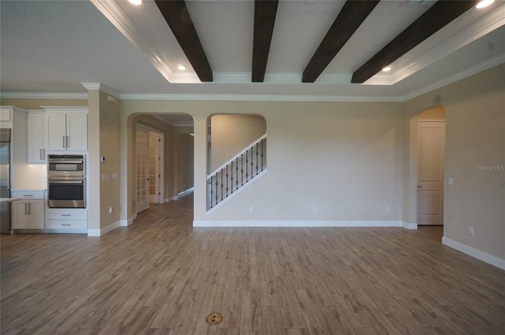 Empty room, Interior, Kitchen, Recessed Lighting, Stainless Steel Appliances, Wooden Beams, Wood Texture Flooring