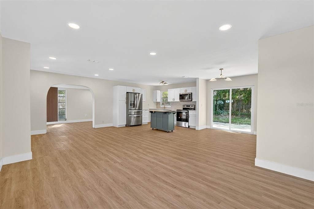 Empty room, Interior, Kitchen, Recessed Lighting, Stainless Steel Appliances, Wood Texture Flooring