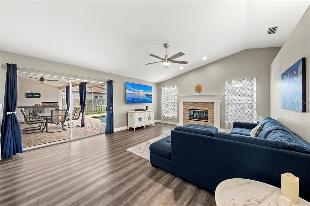 Dining room, Fireplace, Interior, Living room, Recessed Lighting, Wood Texture Flooring