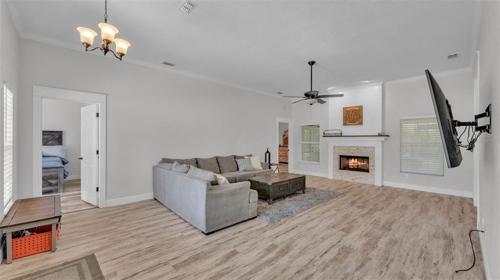 Bedroom, Chandelier, Fireplace, Interior, Living room, Recessed Lighting, Wood Texture Flooring