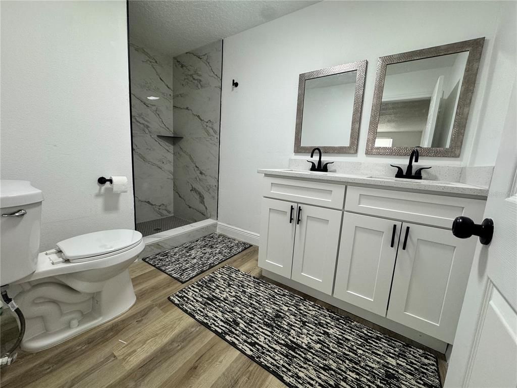 Bathroom, Dual Sink Vanities, Interior, Marble Walls, Wood Texture Flooring