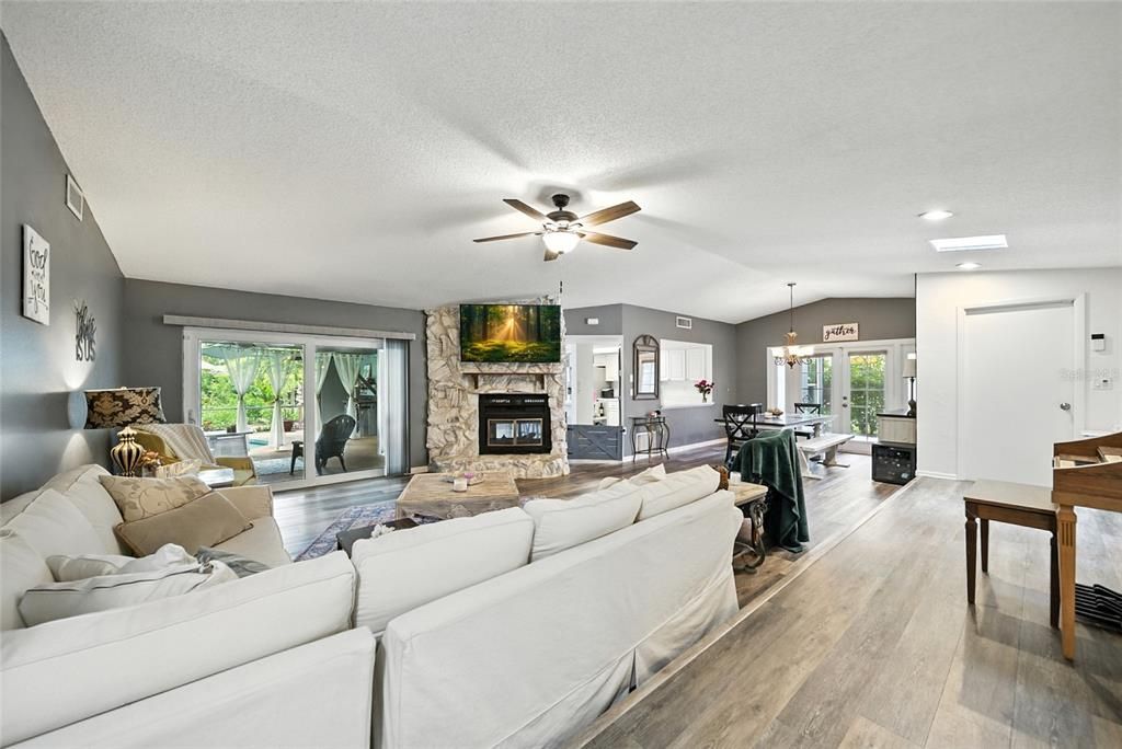 Dining room, Fireplace, Interior, Living room, Pendant Lights, Recessed Lighting, Wood Texture Flooring
