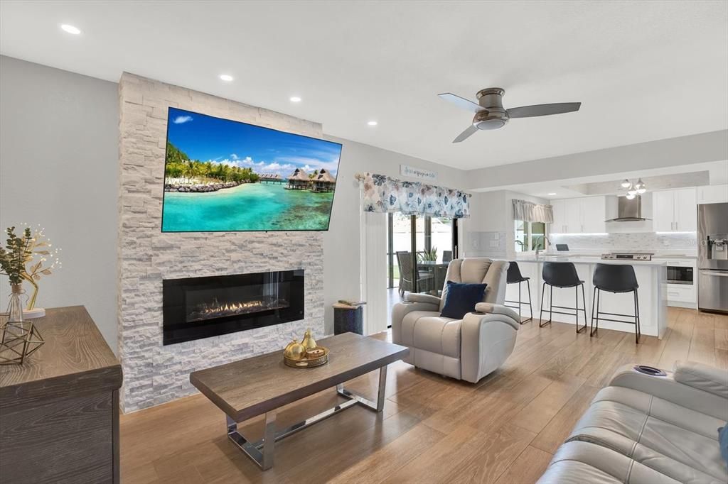 Fireplace, Interior, Kitchen, Living room, Recessed Lighting, Stainless Steel Appliances, Stone Walls, Wood Texture Flooring