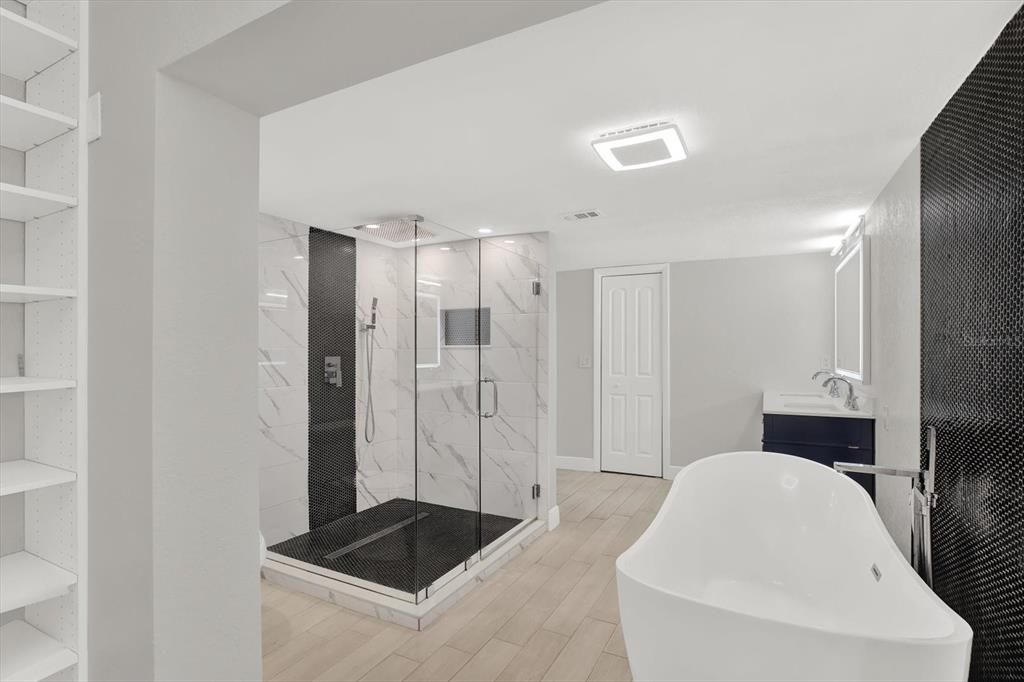 Bathroom, Free Standing Baths, Glass Shower, Interior, Marble Walls, Recessed Lighting, Wood Texture Flooring