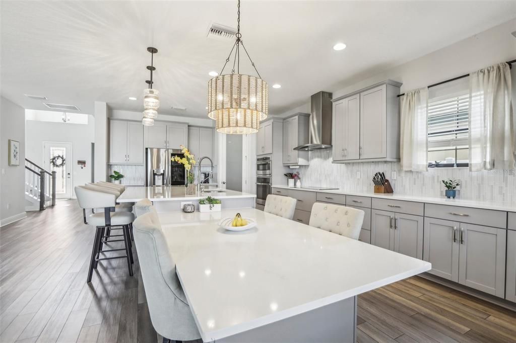 Chandelier, Dining room, Interior, Kitchen, Pendant Lights, Recessed Lighting, Stainless Steel Appliances, Wood Texture Flooring