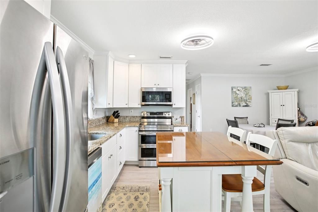 Dining room, Interior, Kitchen, Recessed Lighting, Stainless Steel Appliances, Wood Texture Flooring