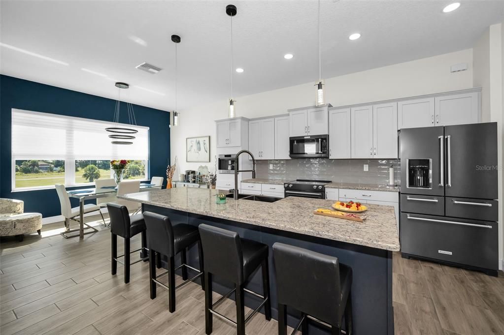 Dining room, Interior, Kitchen, Pendant Lights, Recessed Lighting, Stainless Steel Appliances, Wood Texture Flooring
