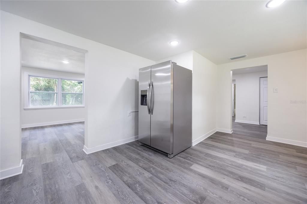 Empty room, Interior, Kitchen, Recessed Lighting, Stainless Steel Appliances, Wood Texture Flooring
