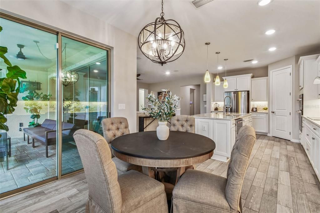 Chandelier, Dining room, Interior, Kitchen, Pendant Lights, Recessed Lighting, Stainless Steel Appliances, Wood Texture Flooring