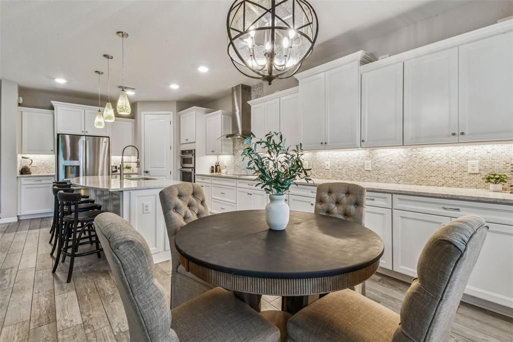 Chandelier, Dining room, Interior, Kitchen, Pendant Lights, Recessed Lighting, Stainless Steel Appliances, Wood Texture Flooring