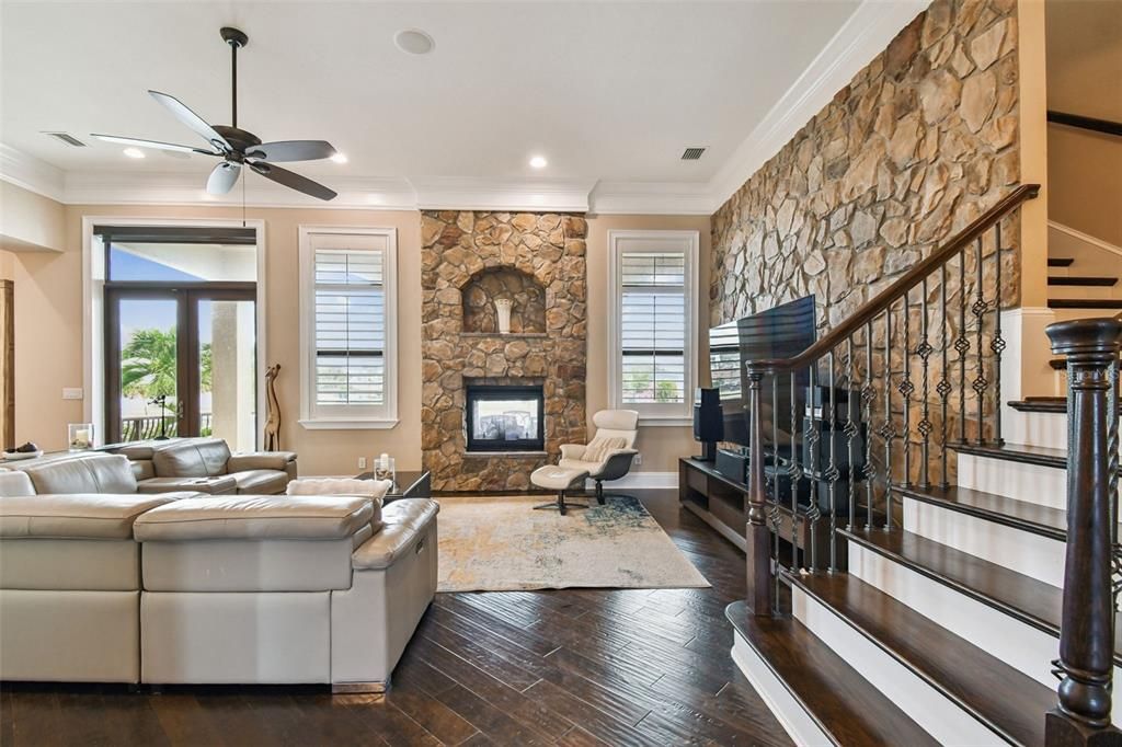 Fireplace, Interior, Living room, Recessed Lighting, Stone Walls, Wood Texture Flooring