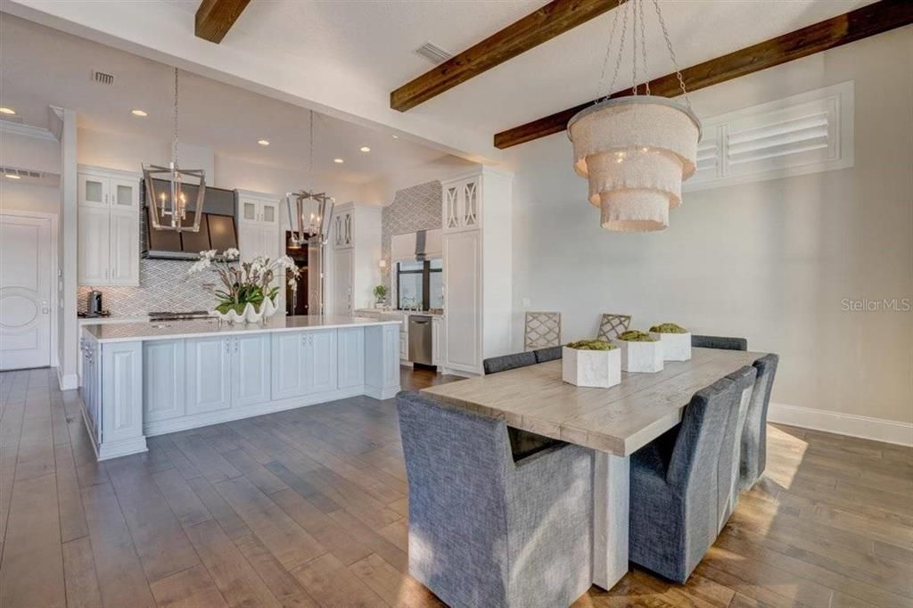 Chandelier, Dining room, Interior, Kitchen, Pendant Lights, Recessed Lighting, Stainless Steel Appliances, Wooden Beams, Wood Texture Flooring