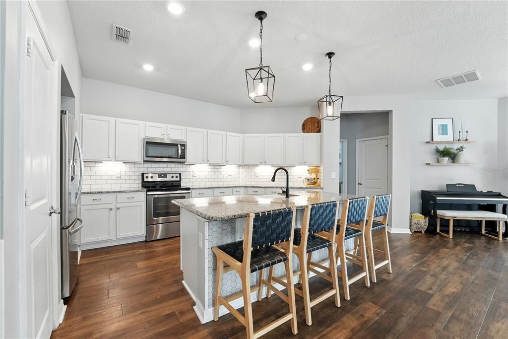 Interior, Kitchen, Pendant Lights, Piano, Recessed Lighting, Stainless Steel Appliances, Wood Texture Flooring