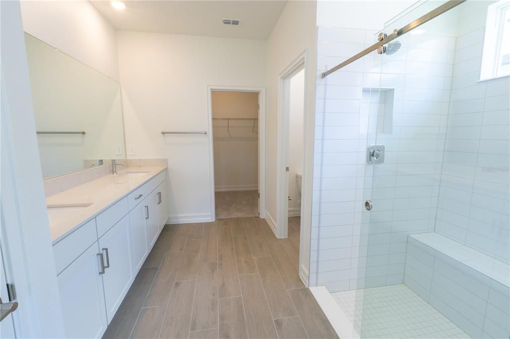 Bathroom, Dual Sink Vanities, Glass Shower, Interior, Recessed Lighting, Walk-in Closets, Wood Texture Flooring