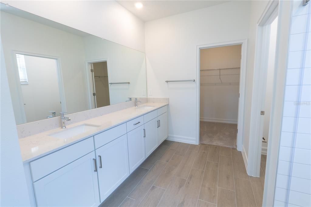 Bathroom, Dual Sink Vanities, Interior, Recessed Lighting, Walk-in Closets, Wood Texture Flooring