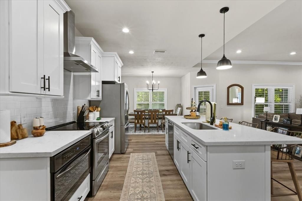 Chandelier, Dining room, Interior, Kitchen, Pendant Lights, Recessed Lighting, Stainless Steel Appliances, Wood Texture Flooring