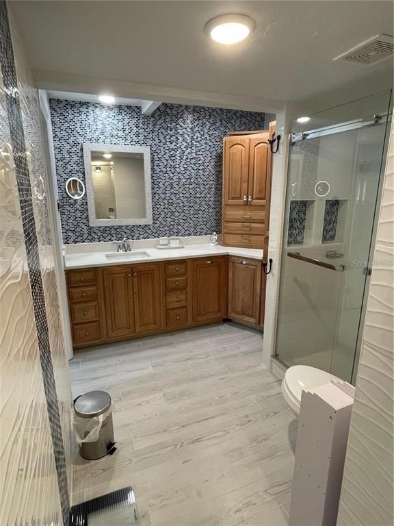 Bathroom, Dual Sink Vanities, Glass Shower, Interior, Recessed Lighting, Wood Texture Flooring