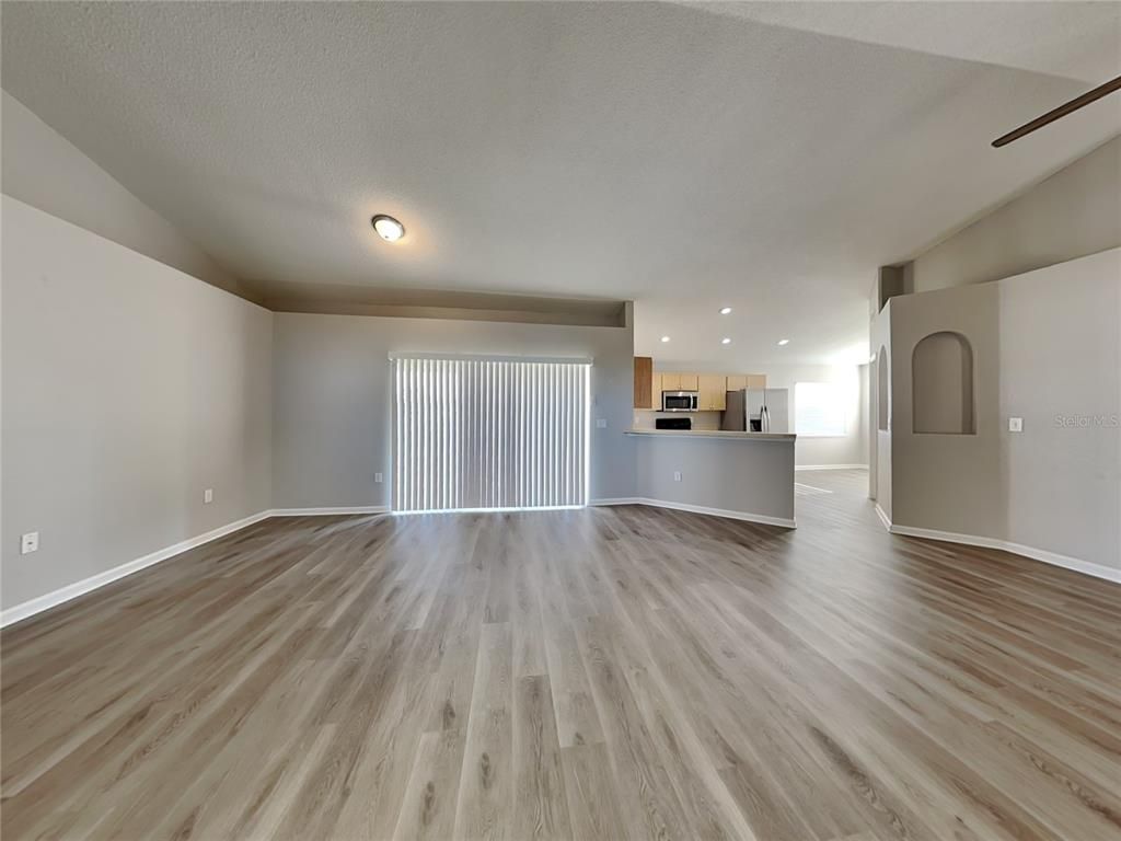 Empty room, Interior, Kitchen, Recessed Lighting, Stainless Steel Appliances, Wood Texture Flooring