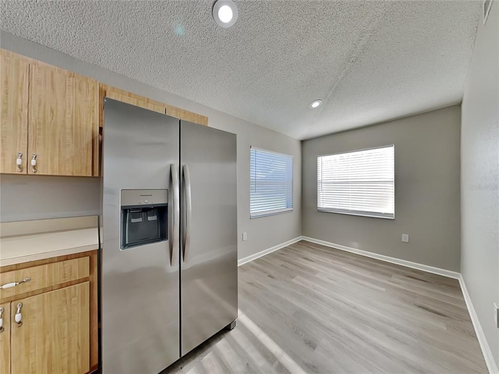 Empty room, Interior, Kitchen, Recessed Lighting, Stainless Steel Appliances, Wood Texture Flooring