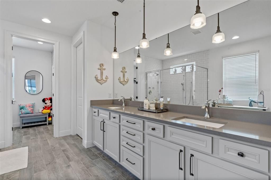 Bathroom, Dual Sink Vanities, Glass Shower, Interior, Pendant Lights, Recessed Lighting, Wood Texture Flooring