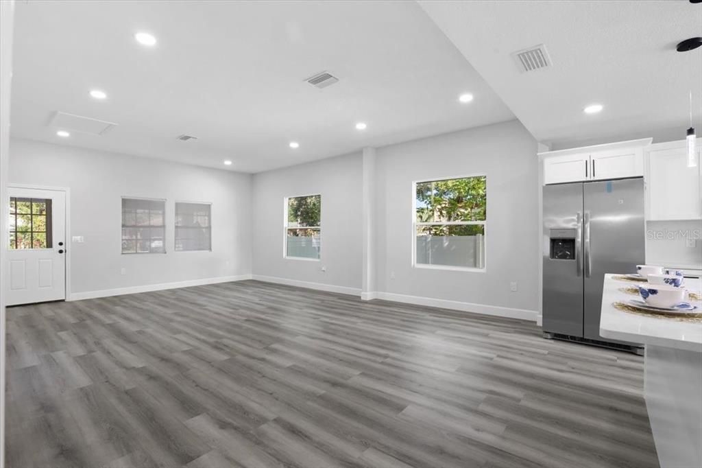 Empty room, Interior, Kitchen, Recessed Lighting, Stainless Steel Appliances, Wood Texture Flooring