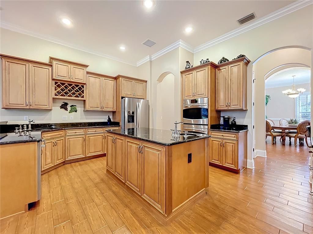 Chandelier, Dining room, Interior, Kitchen, Recessed Lighting, Stainless Steel Appliances, Wood Texture Flooring
