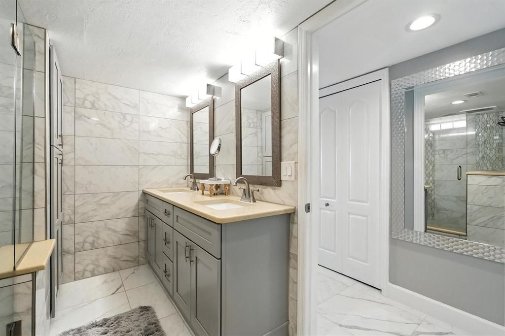 Bathroom, Dual Sink Vanities, Glass Shower, Interior, Marble, Marble Walls, Recessed Lighting