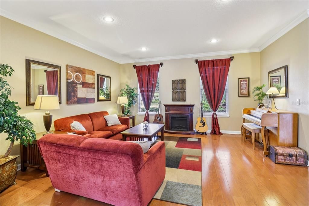Fireplace, Interior, Living room, Piano, Recessed Lighting, Wood Texture Flooring