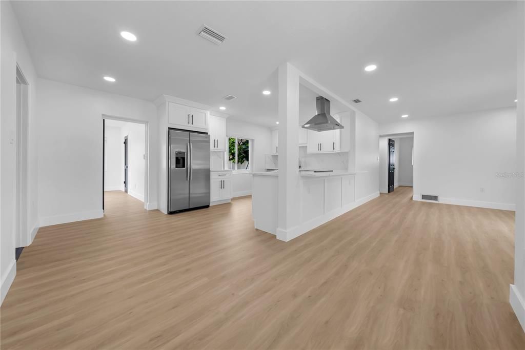 Empty room, Interior, Kitchen, Recessed Lighting, Stainless Steel Appliances, Wood Texture Flooring