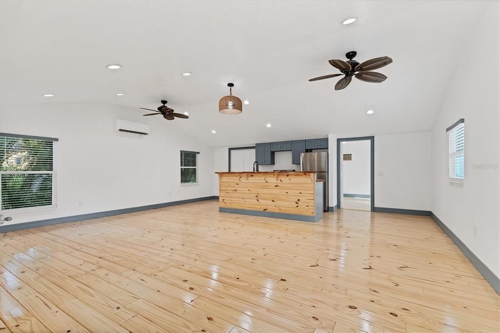 Empty room, Interior, Kitchen, Pendant Lights, Recessed Lighting, Stainless Steel Appliances, Wood Texture Flooring