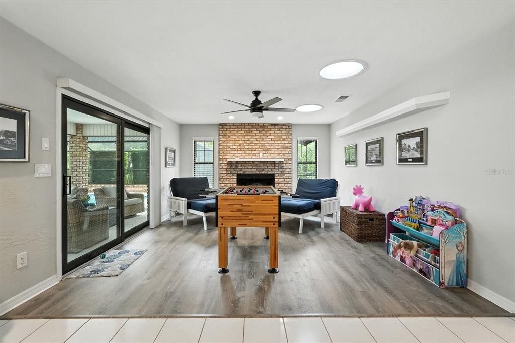 Fireplace, Interior, Living room, Recessed Lighting, Stone Walls, Wood Texture Flooring