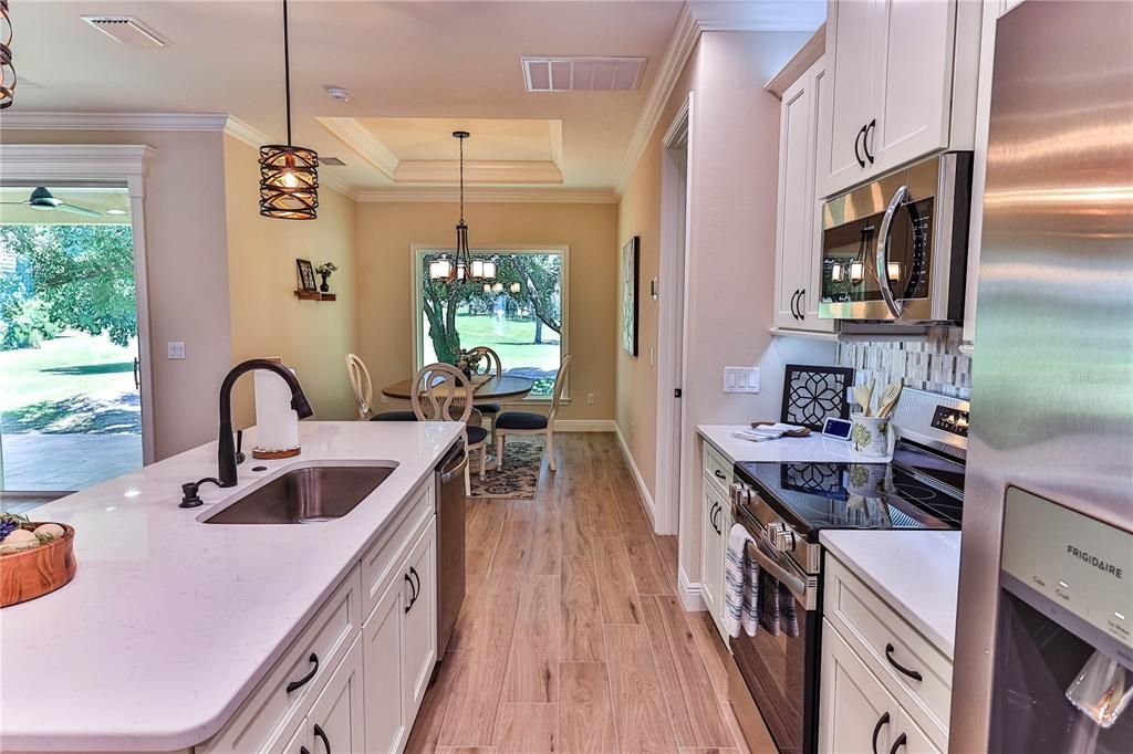 Chandelier, Dining room, Interior, Kitchen, Pendant Lights, Stainless Steel Appliances, Wood Texture Flooring