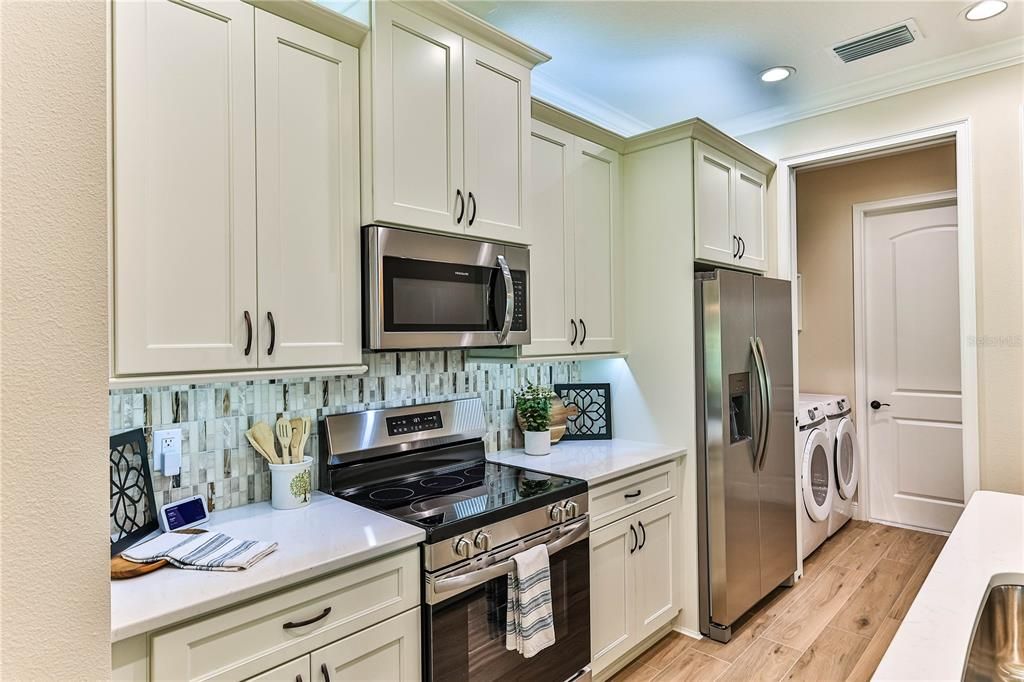 Interior, Kitchen, Recessed Lighting, Stainless Steel Appliances, Washer, Wood Texture Flooring