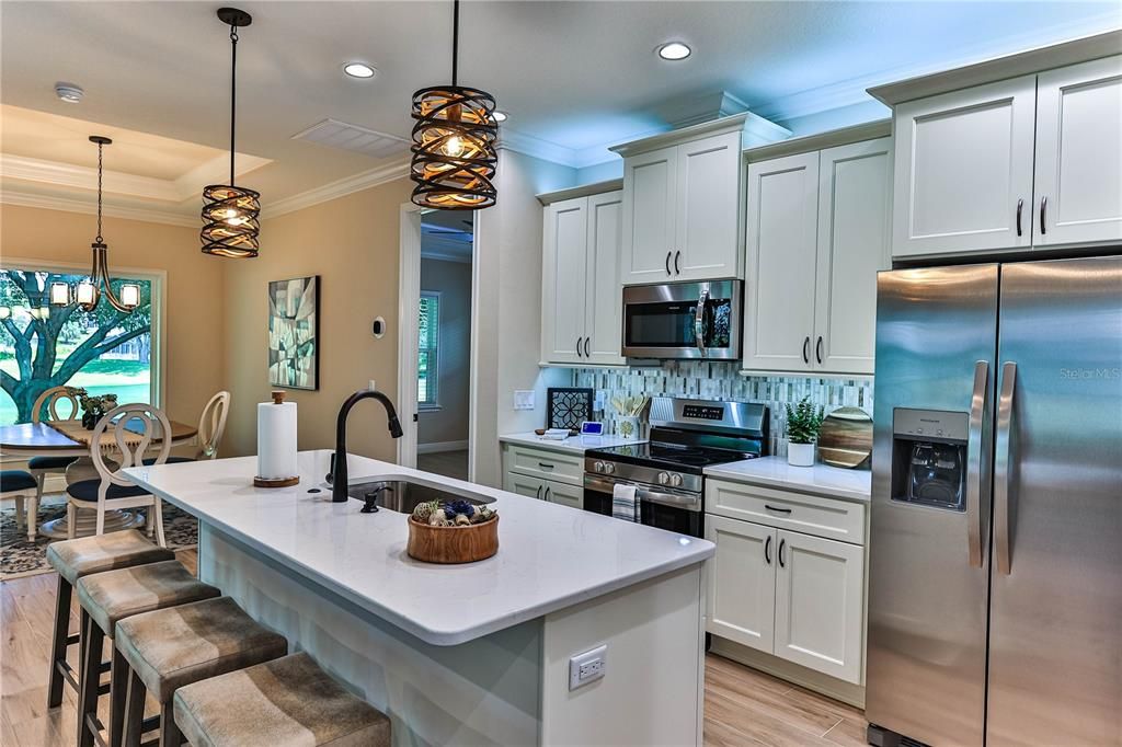 Dining room, Interior, Kitchen, Pendant Lights, Recessed Lighting, Stainless Steel Appliances, Wood Texture Flooring
